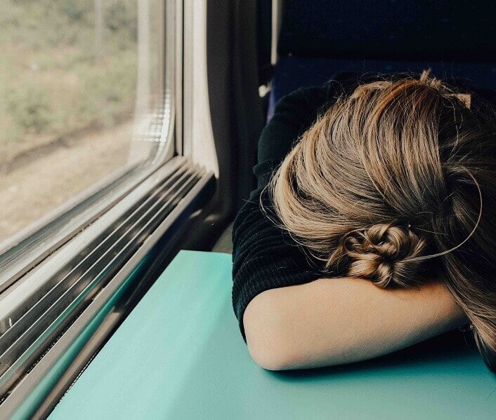 Woman asleep on a train