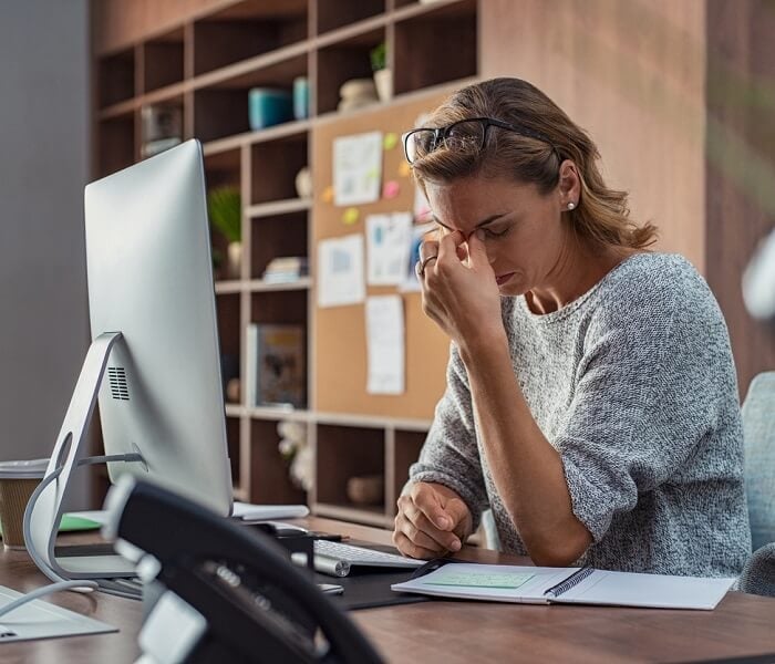 Business woman having headache at office