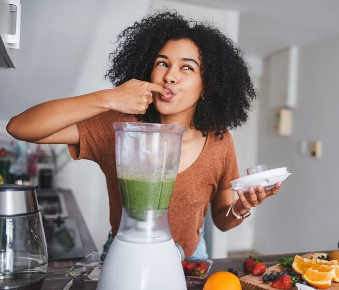 Woman tasting a smoothie