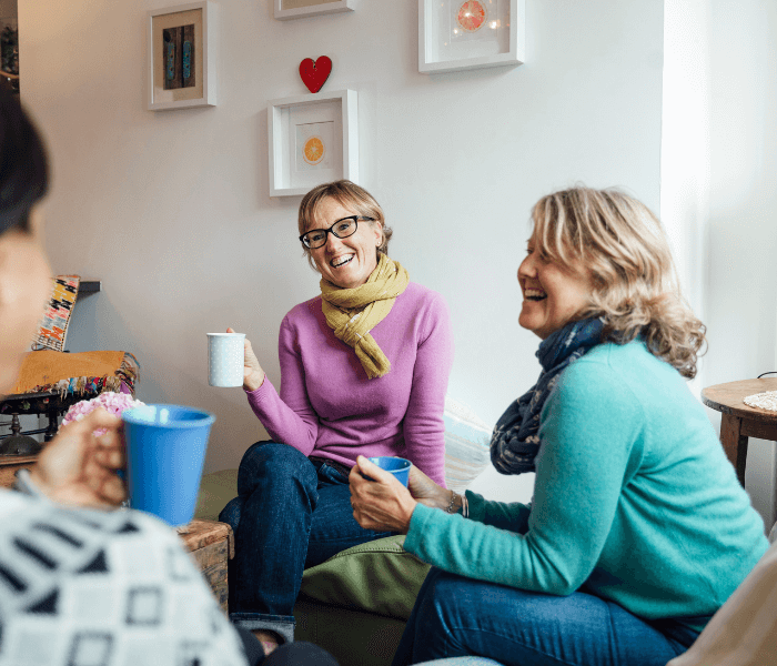 Women smile having a cup of tea