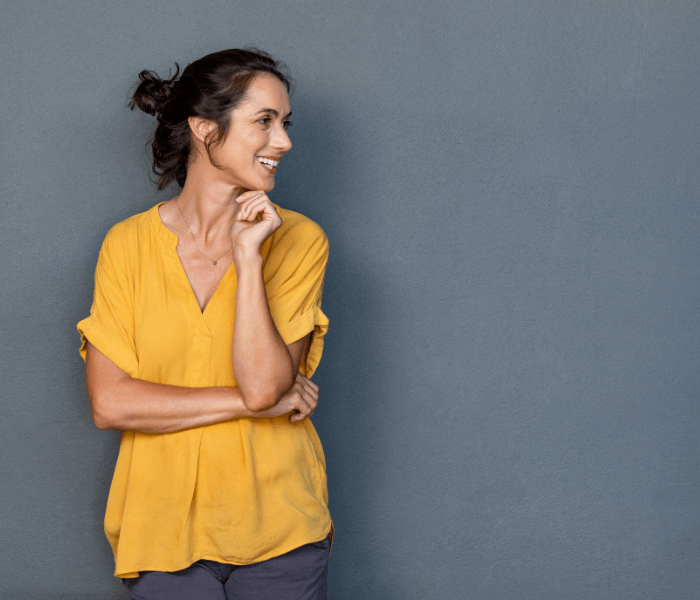 Woman standing looking to the right smiling