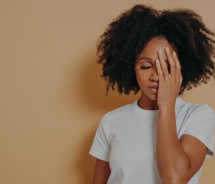 Woman with hand on her face