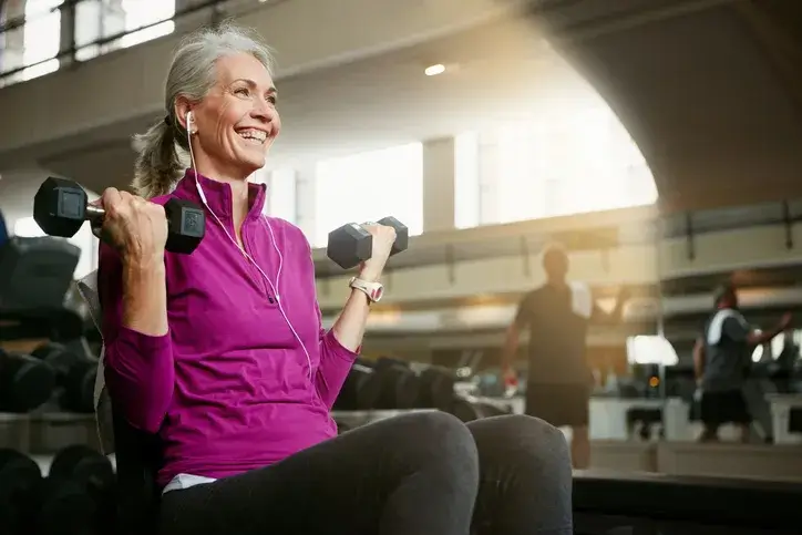 Menopausal woman lifting weights to help with osteopenia and osteoporosis
