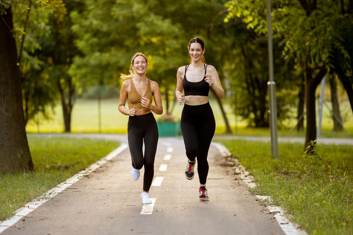 Two female runners in a park