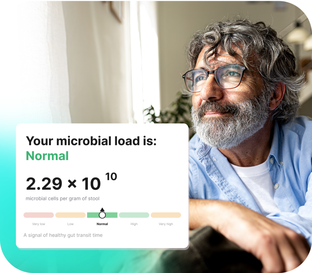 A man looking thoughtfully out of a window alongside his Forth gut health test result, showing a normal microbial load of 2.29 × 10¹⁰ cells per gram of stool — a signal of healthy gut transit time.